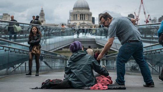 A volunteer helping a homeless person